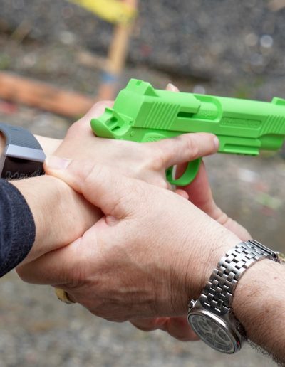 Close up of hands on fake firearm during safety training