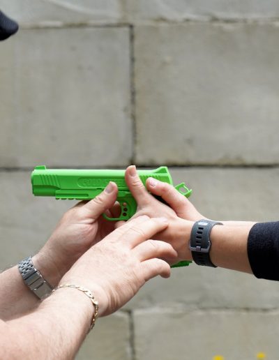 Close up of hands on fake firearm during safety training